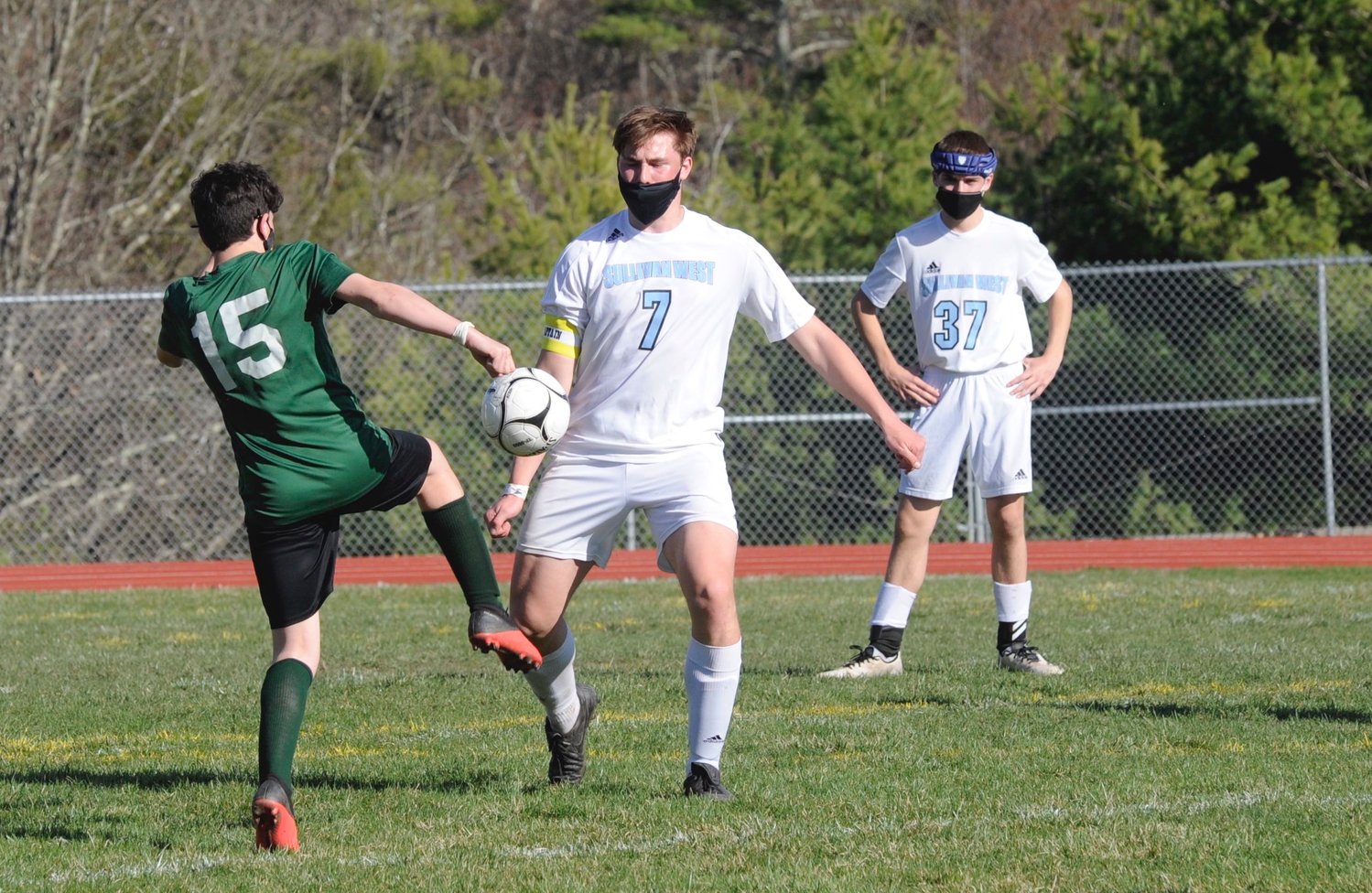 Dueling booters. Eldred’s Sean Whalan and Sullivan West’s Ryan Mace, who later scored the Bulldogs winning goal in the second frame. Pictured in the background is Sullivan West’s Michael Schroeder.